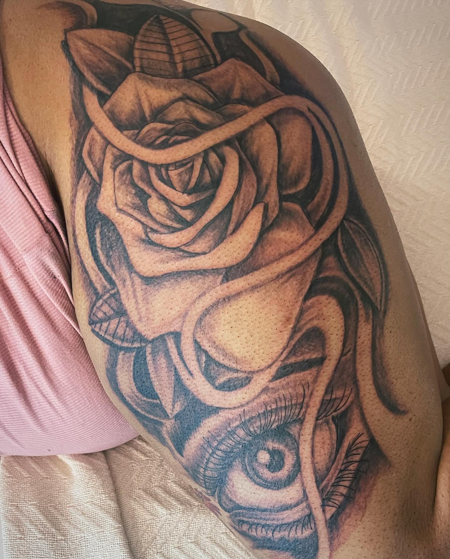 Rose realism tattoo on the thigh by Azaan (Zanye), Birmingham, Alabama