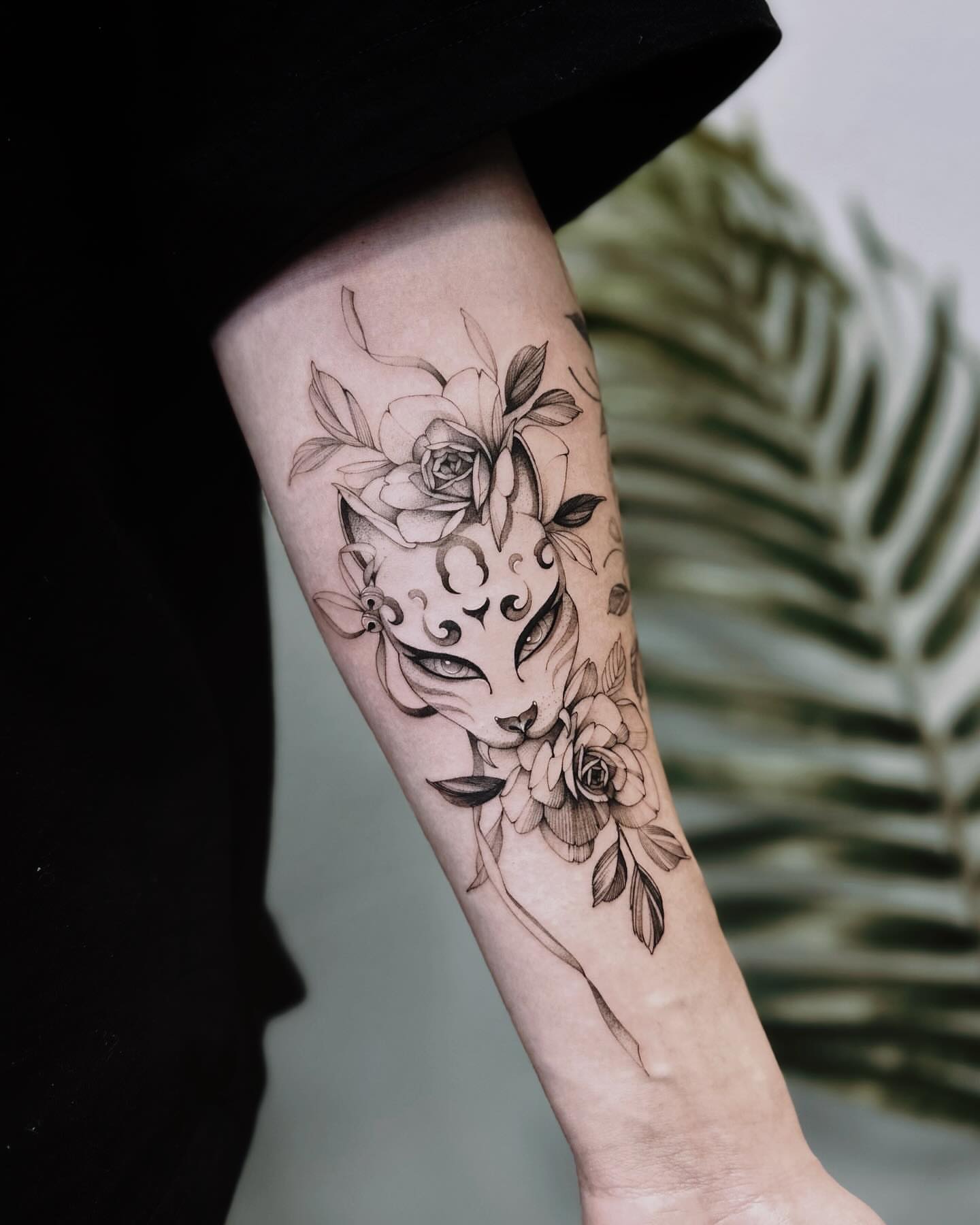 Cat and flowers realism tattoo on the forearm by Angel