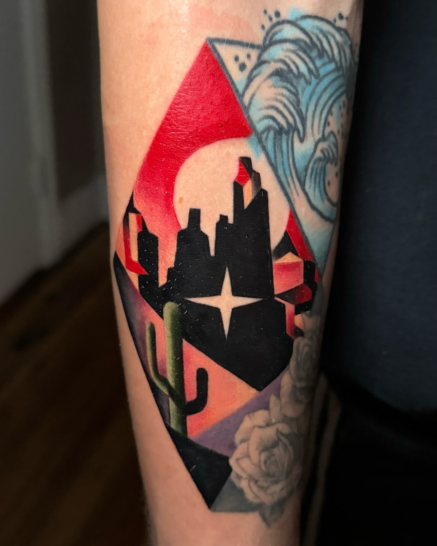Cityscape with cactus geometric tattoo on the forearm by East Coast Rico