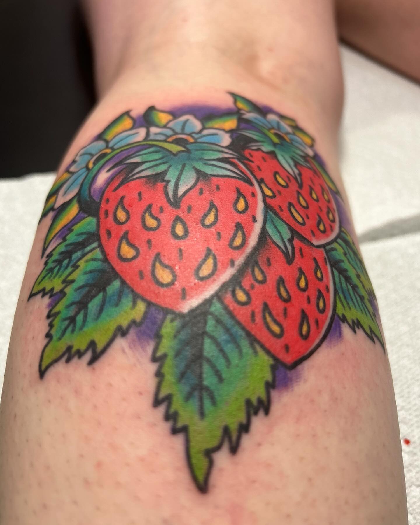 Strawberries American traditional tattoo on the forearm by Alex Fannin