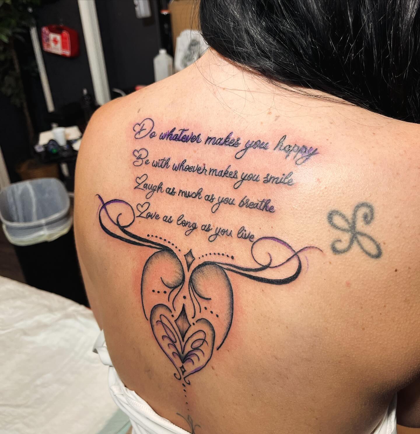 Heart with inspirational quote fine line tattoo on the back by Alesia