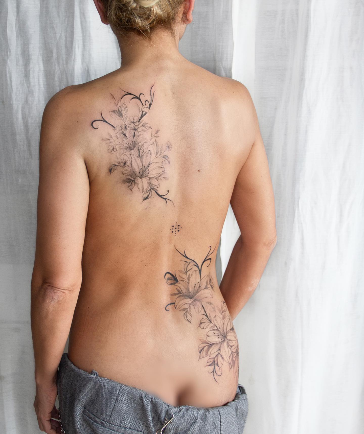 Lily flowers black and grey tattoo on the back by Liv