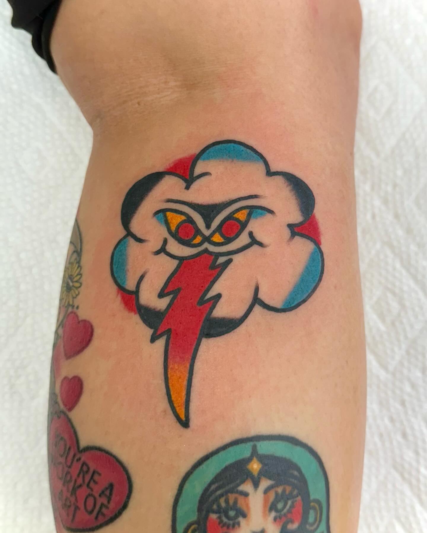 Storm cloud with lightning bolt American traditional tattoo on the forearm by Nicholas Mella, Nashville, Tennessee