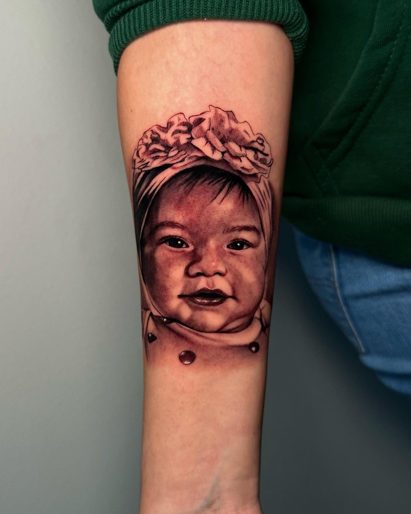 Baby portrait realism tattoo on the forearm by Kiki Tattoos😈