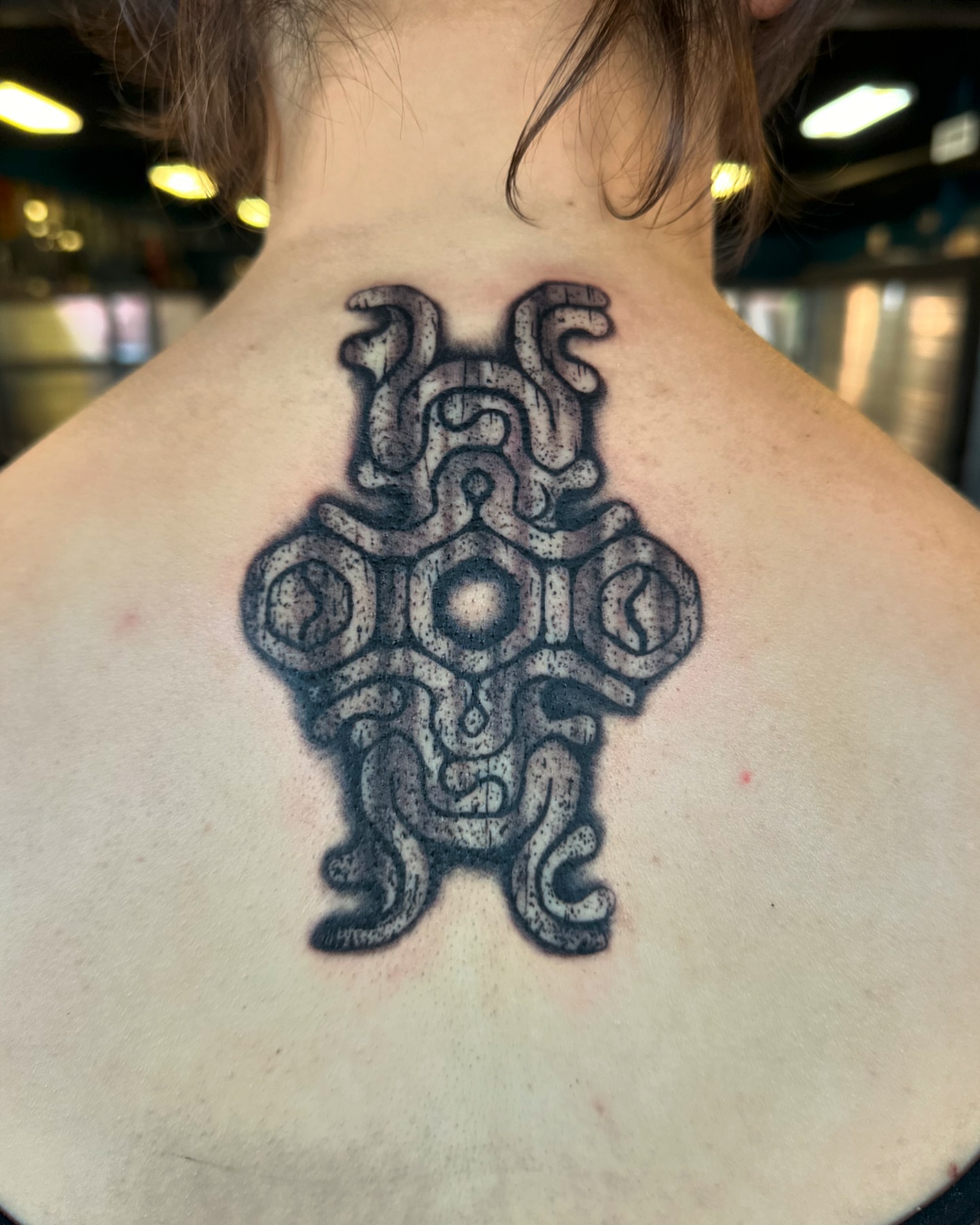 Geometric symbol dotwork tattoo on the back by (Joshua) Van Cummings