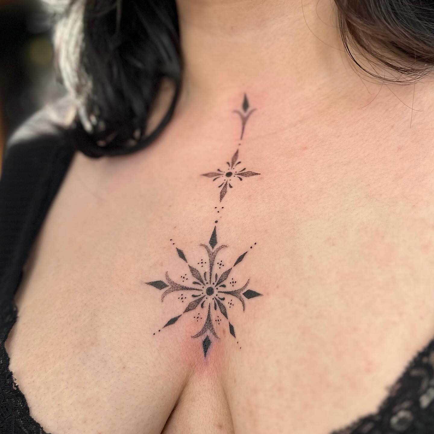 Geometric starburst dotwork tattoo on the chest by Kerusha (Bay Area Tattoo Artist)
