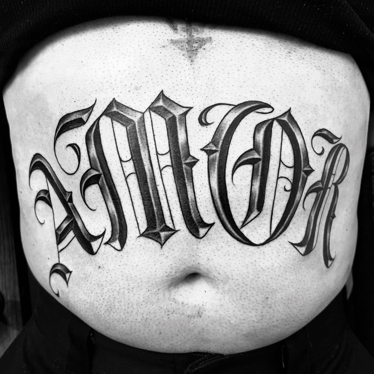 Gothic script lettering script tattoo on the torso by F e A R