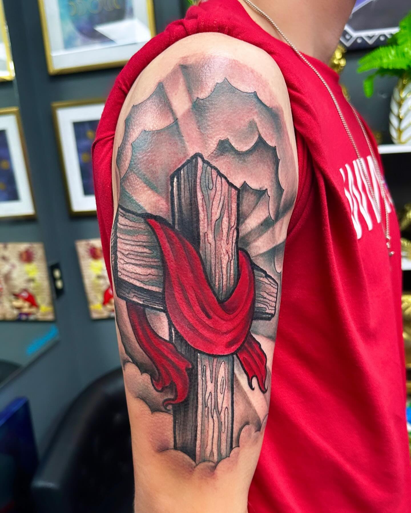 Cross with red cloth American traditional tattoo on the forearm by Labbé
