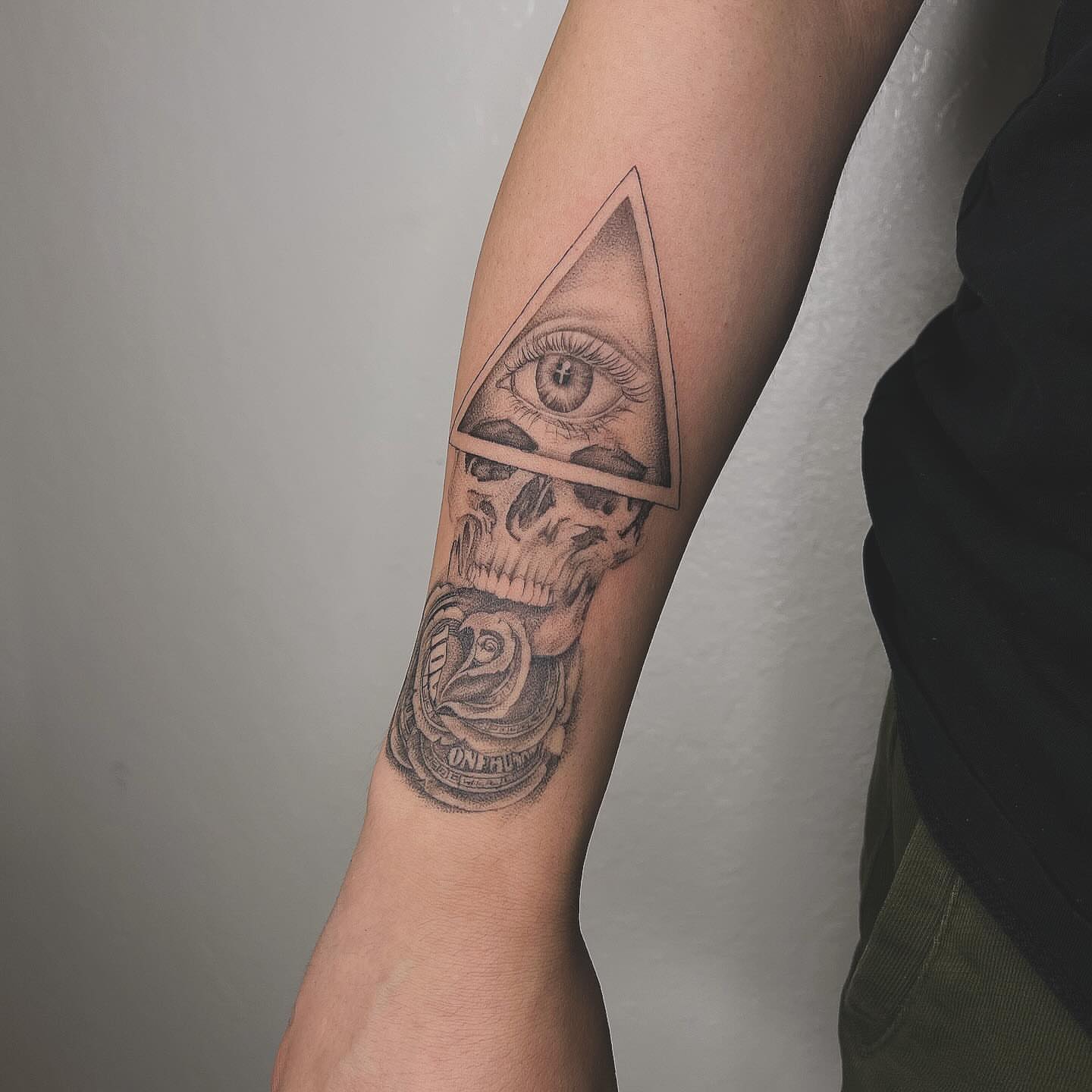 Eye and skull geometric tattoo on the forearm by Jocelyn