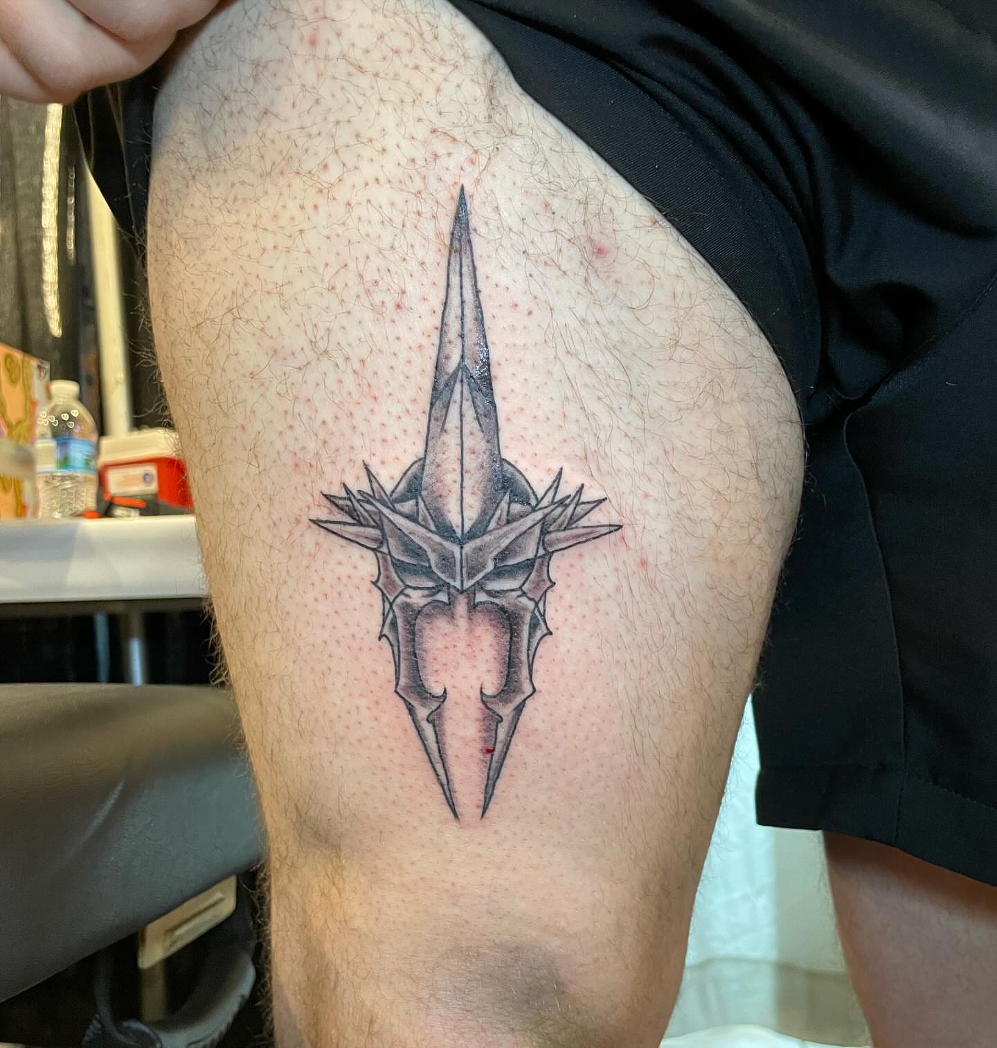 Spiked helmet geometric tattoo on the thigh by Kimberly Shordon