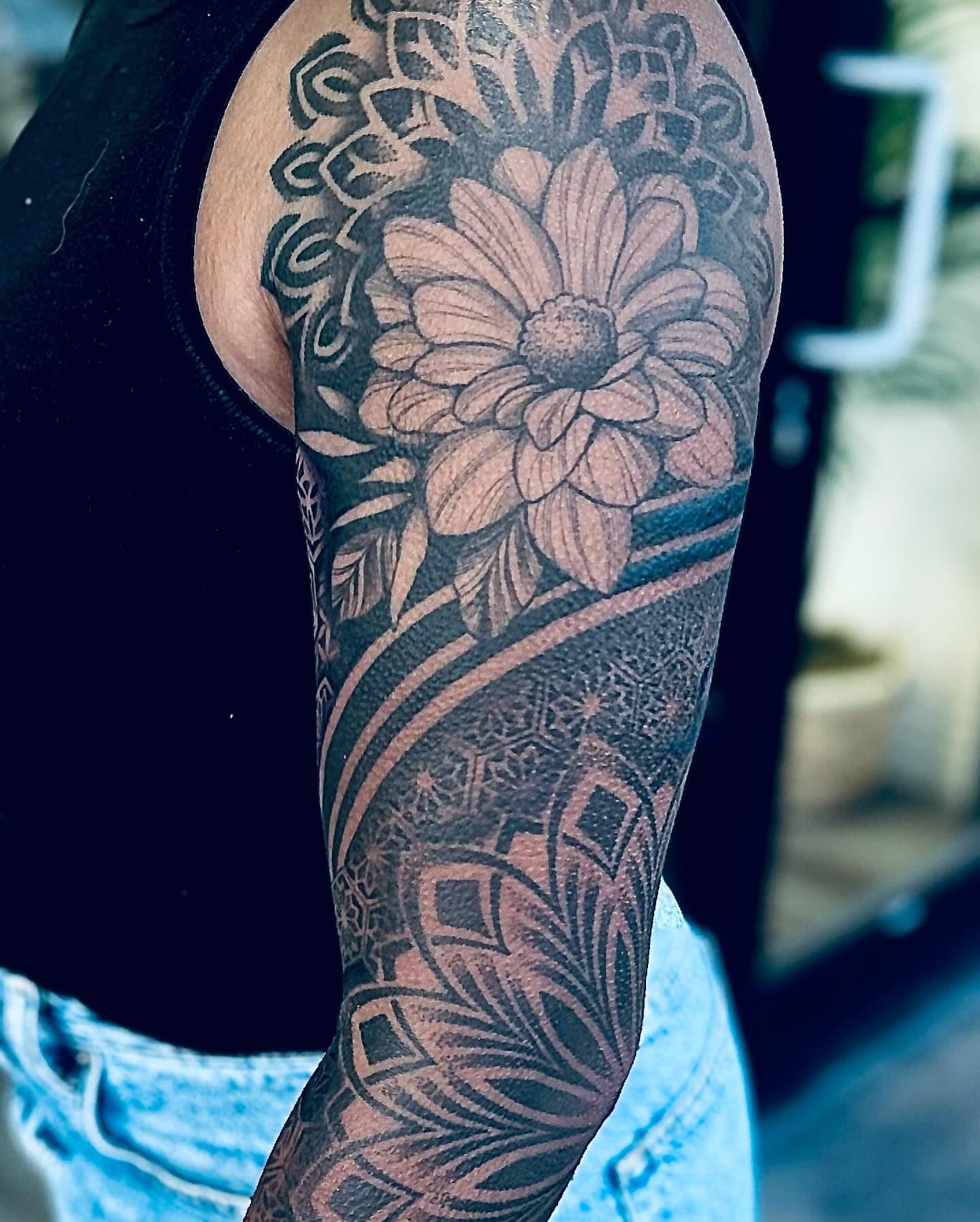 Flower black and grey tattoo on the forearm by Juan Carlos
