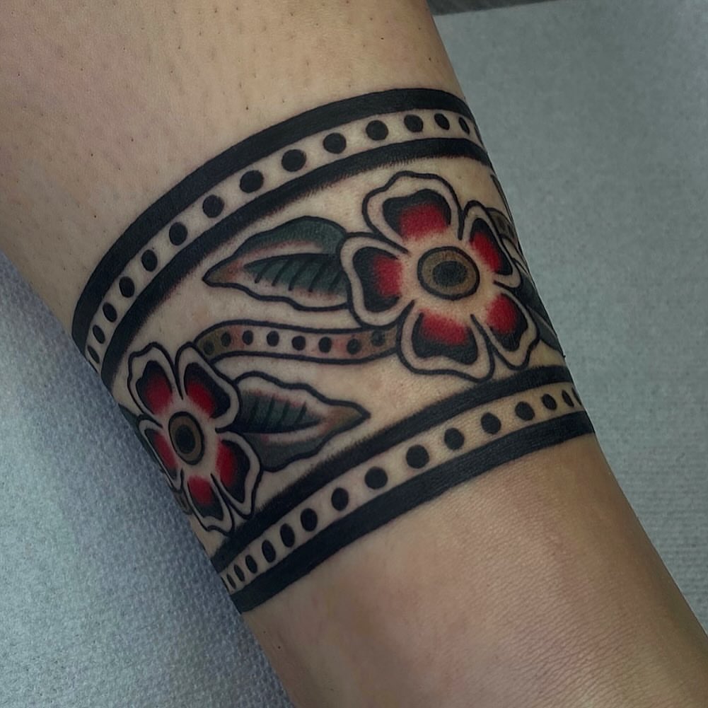 Floral band American traditional tattoo on the forearm by Erin Chambers