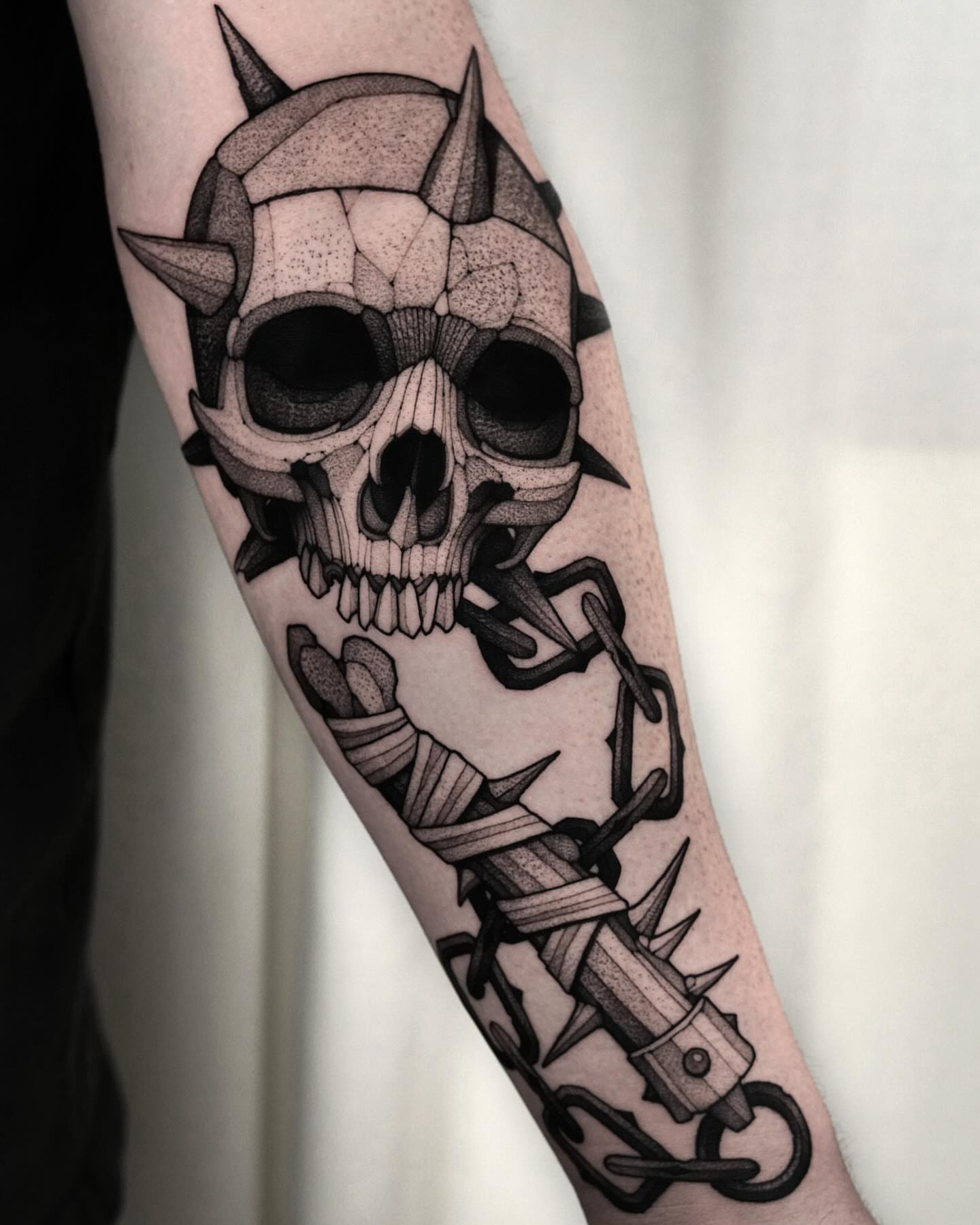 Skull and chain dotwork tattoo on the forearm by Max LaCroix