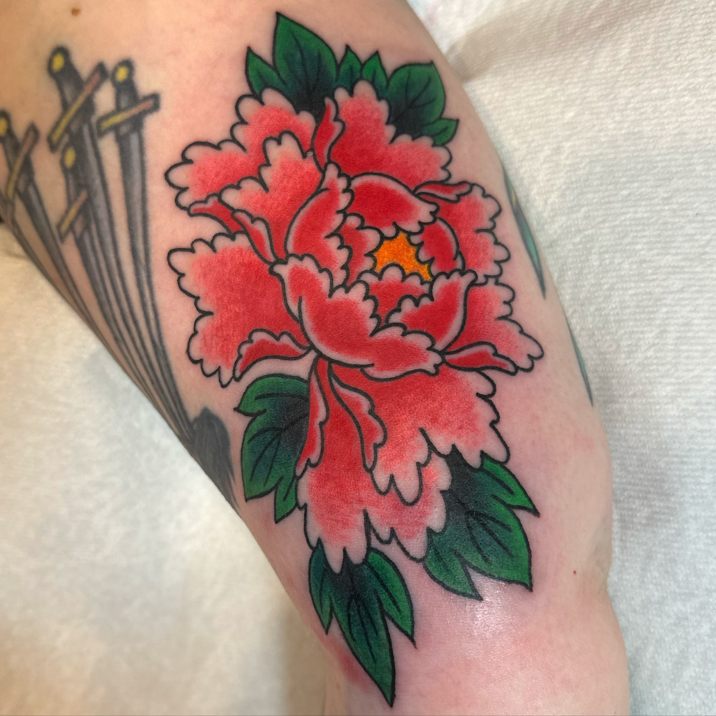 Peony American traditional tattoo on the forearm by Daniel Skillingstead