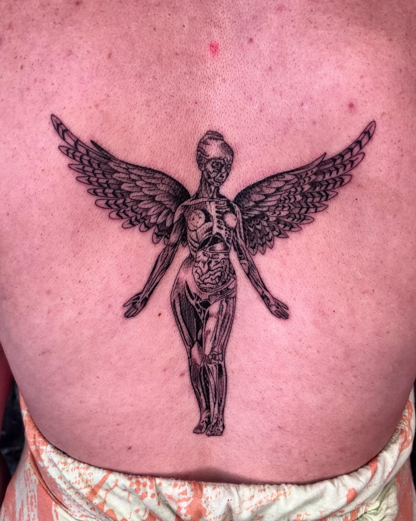 Anatomical figure with wings black and grey tattoo on the back by zach arlan, Kansas City, Missouri