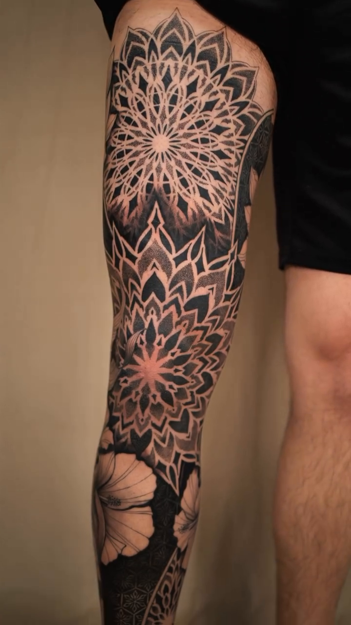 Mandala and floral leg sleeve geometric tattoo by Laure Conzales