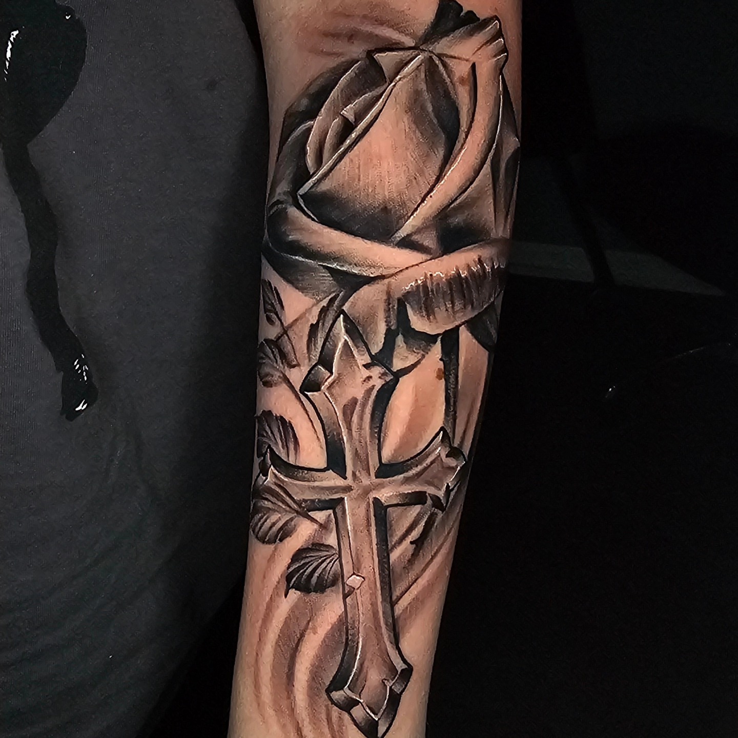 Cross and rose realism tattoo on the forearm by Christian Mulvey