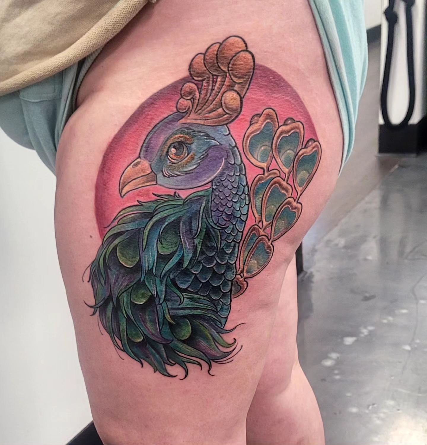 Peacock realism tattoo on the thigh by Dawne Michele