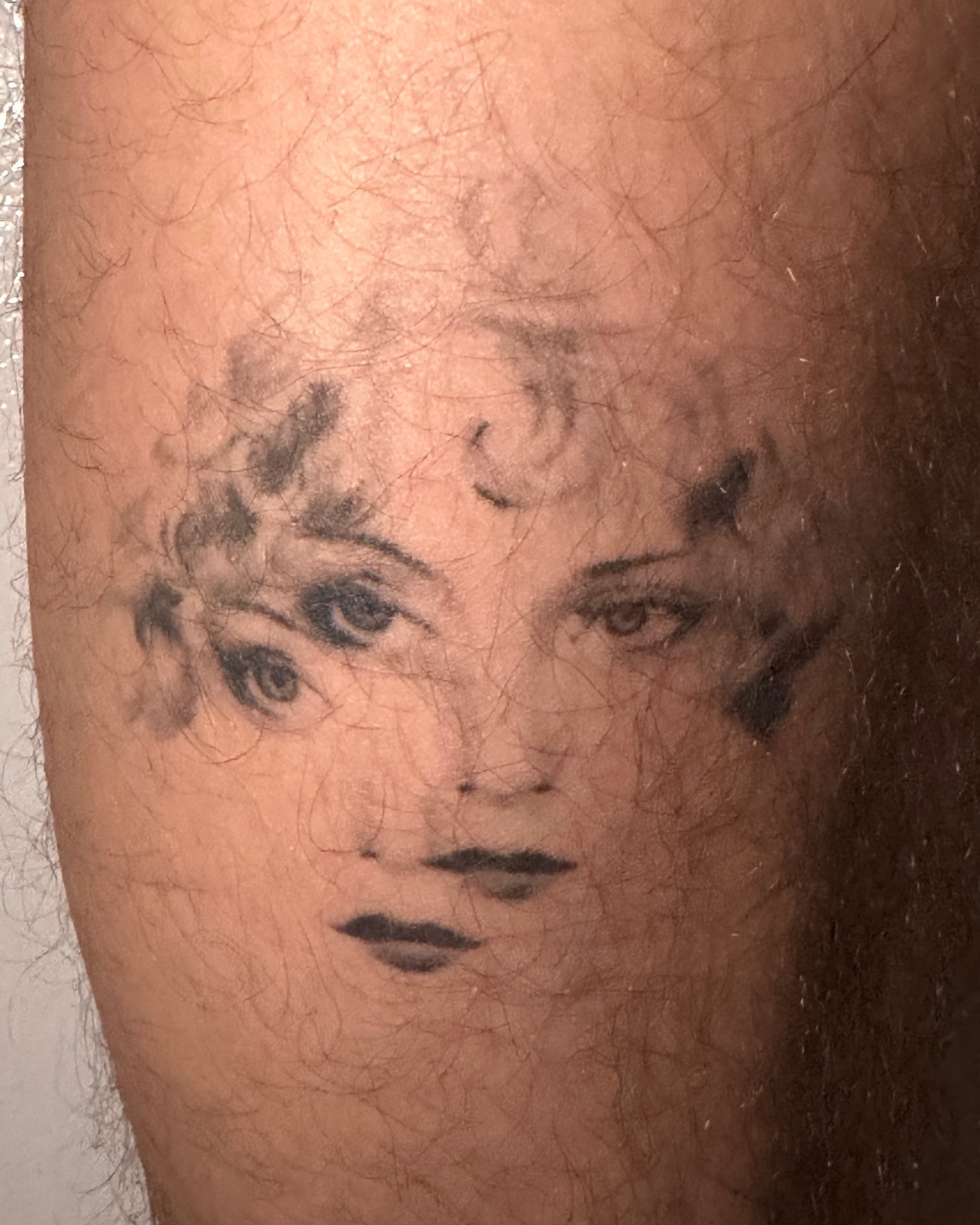 Woman's face black and grey tattoo on the forearm by Hayley Jude