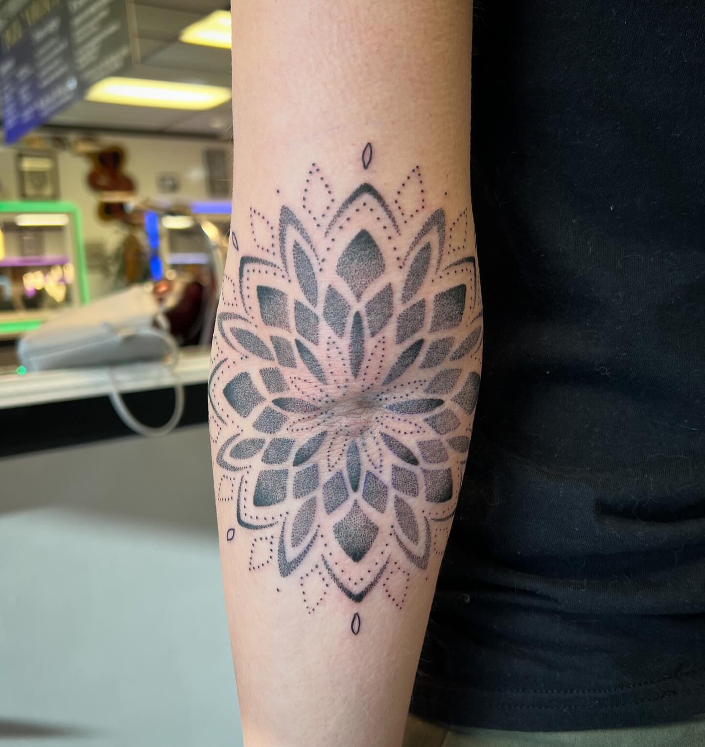 Lotus flower dotwork tattoo on the forearm by Brooke, Kansas City, Missouri