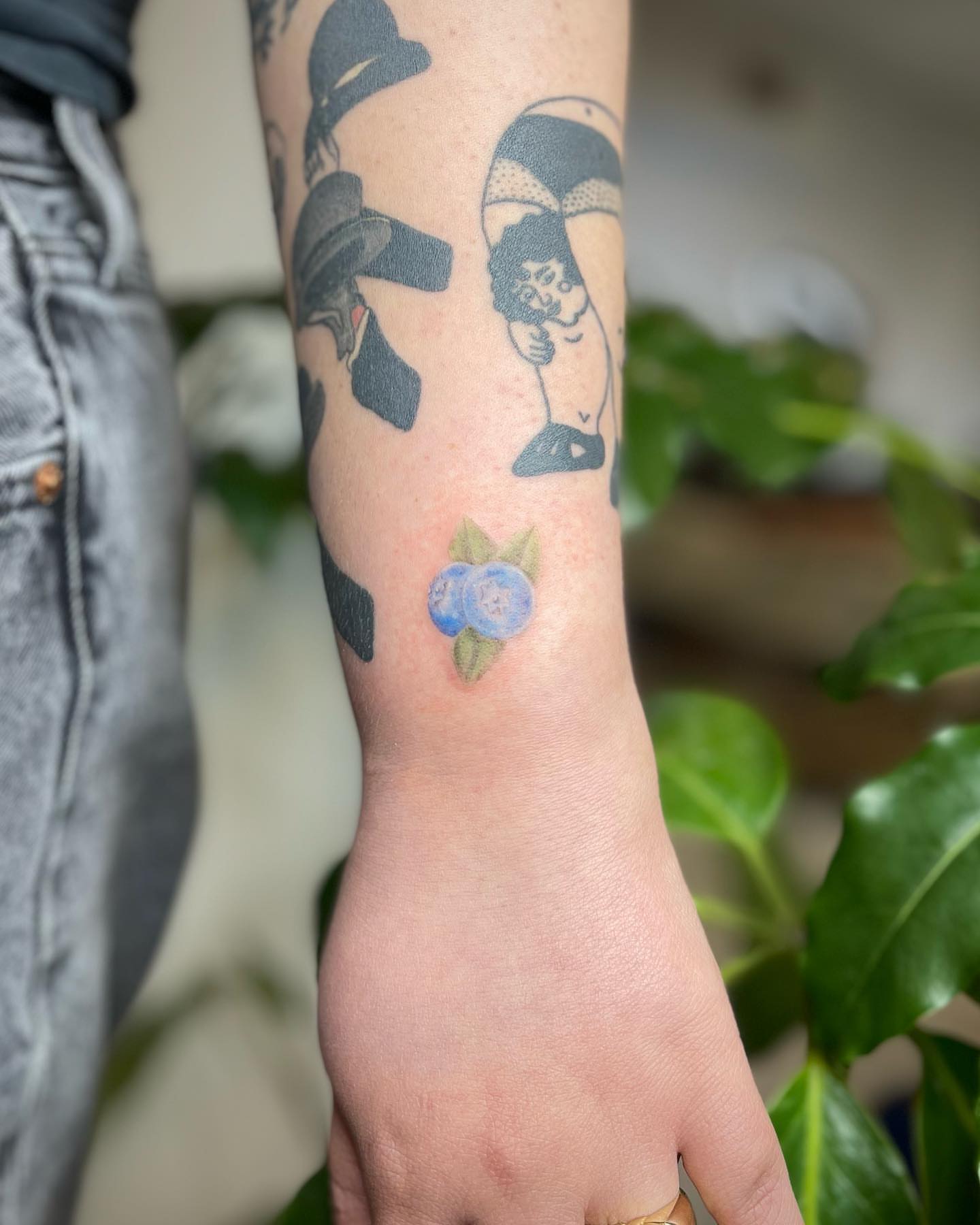 Blueberries realism tattoo on the forearm by Jennifer Fuster