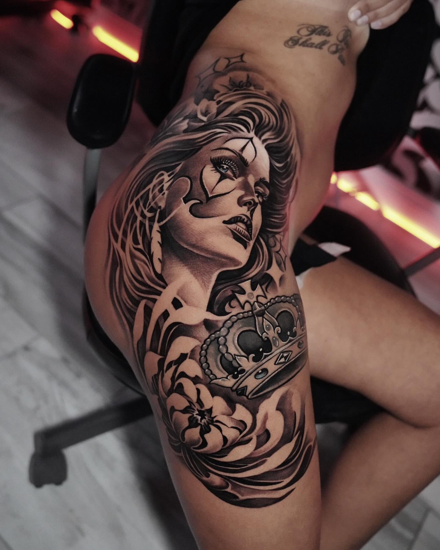 Woman with crown realism tattoo on the thigh by Artem Kunakuzin