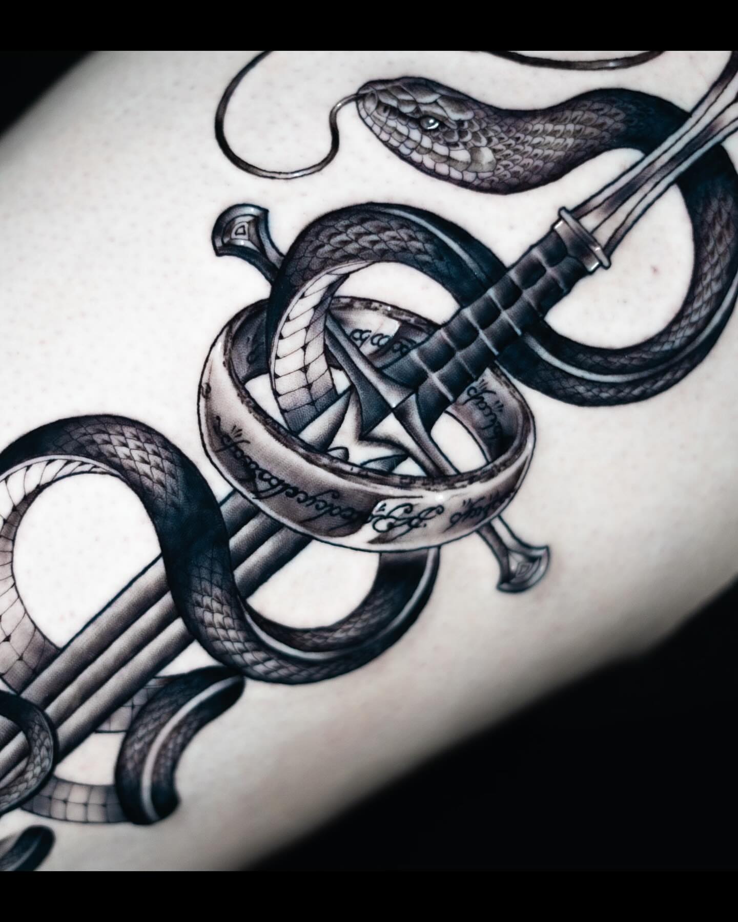 Snake and sword realism tattoo on the forearm by James Jurado
