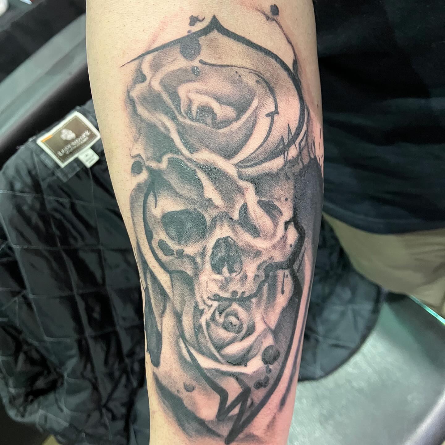 Skull and rose realism tattoo on the forearm by Hot Dawg