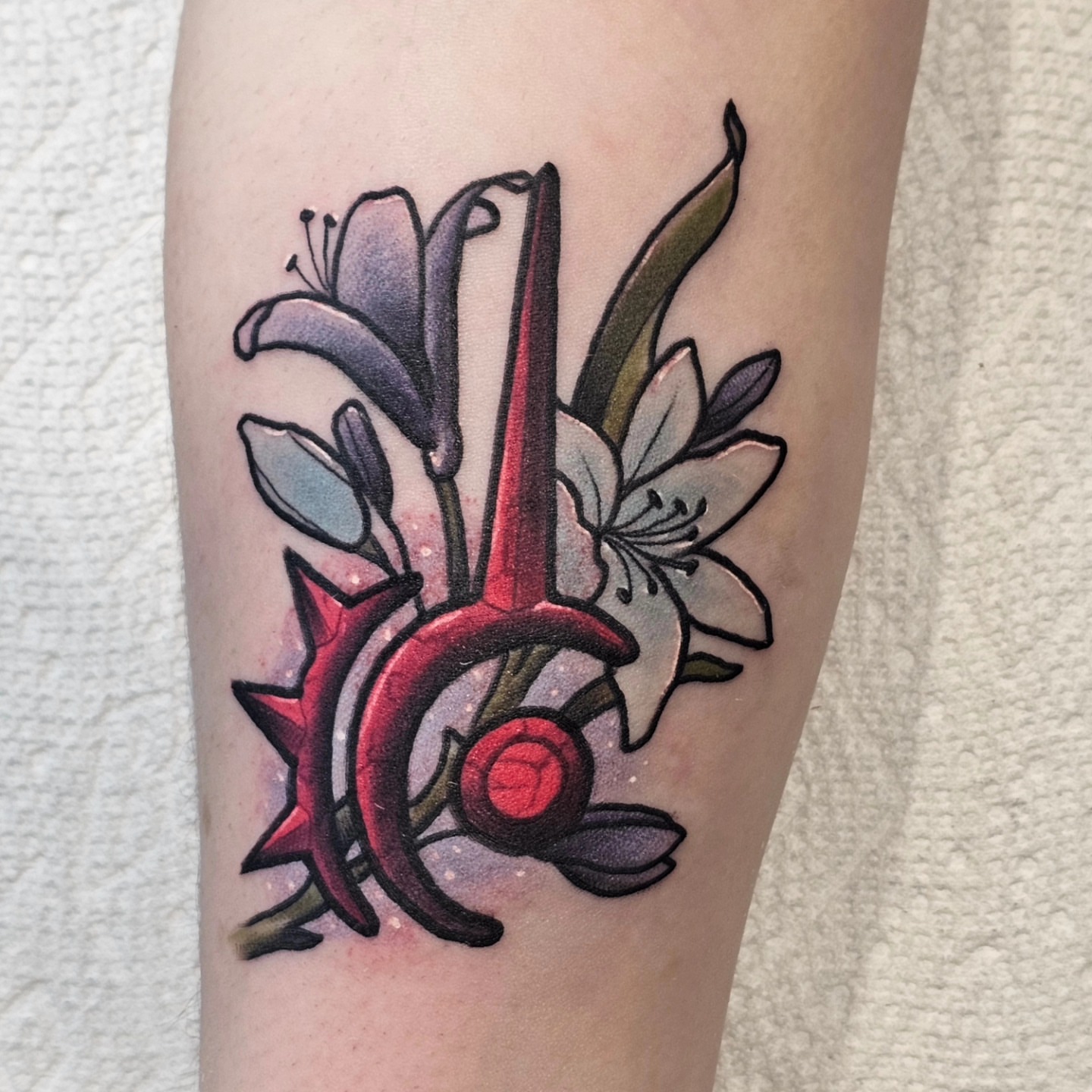 Lilies and heart American traditional tattoo on the forearm by BZ Artistry