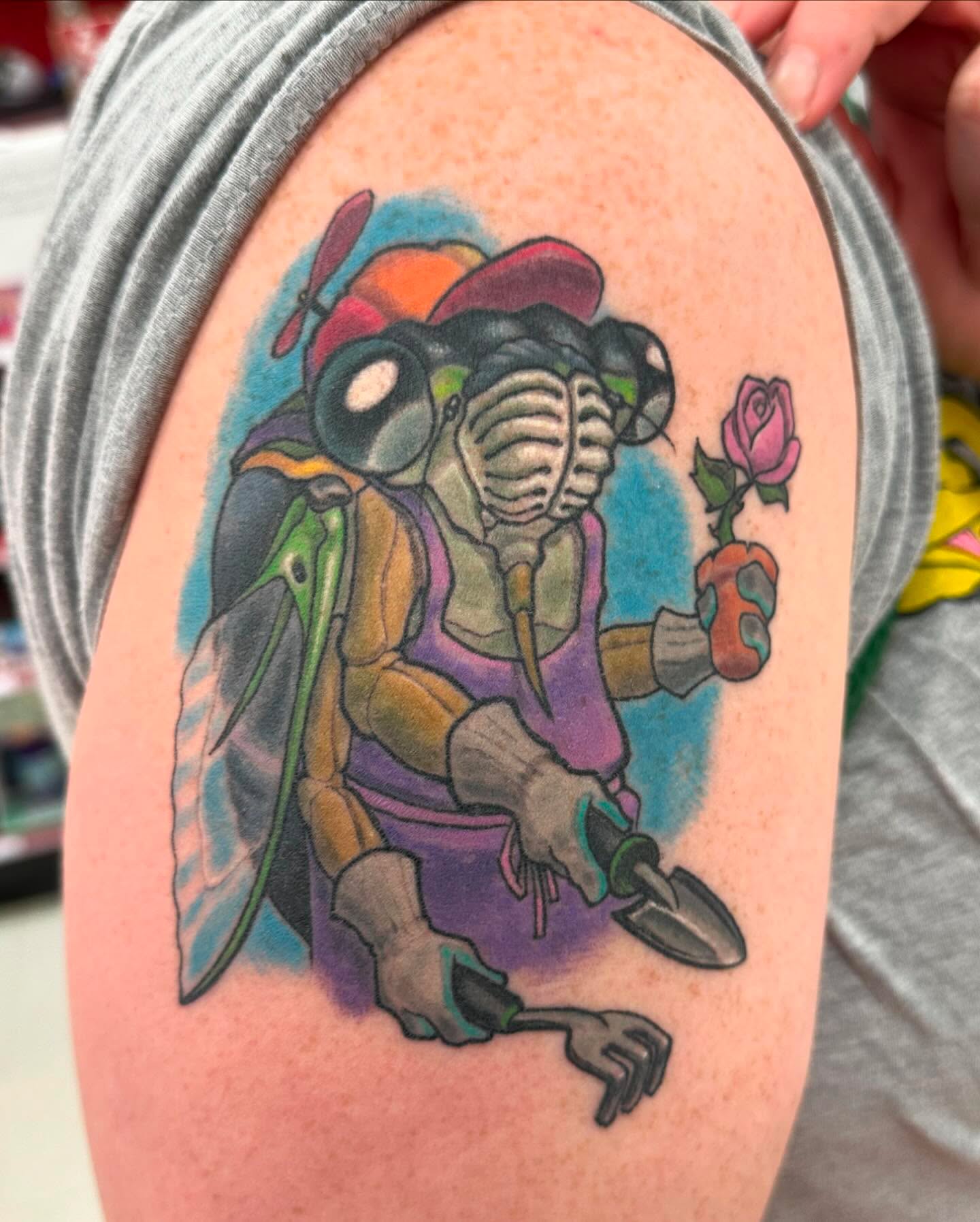 Turtle with rose new school tattoo on the upper arm by shane baker