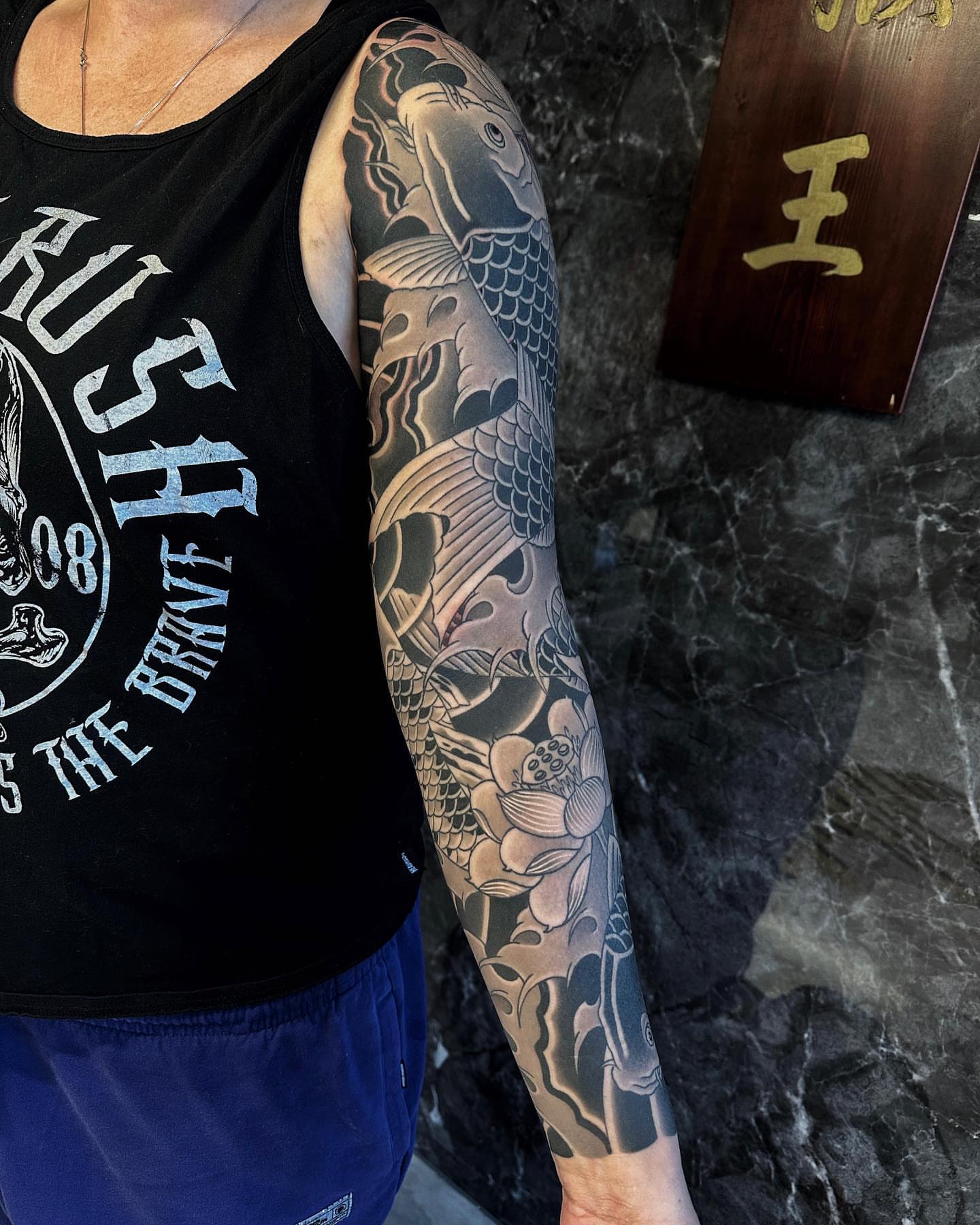 Koi fish and lotus japanese irezumi tattoo on the forearm by Xiaojun Yin, Vancouver, British Columbia
