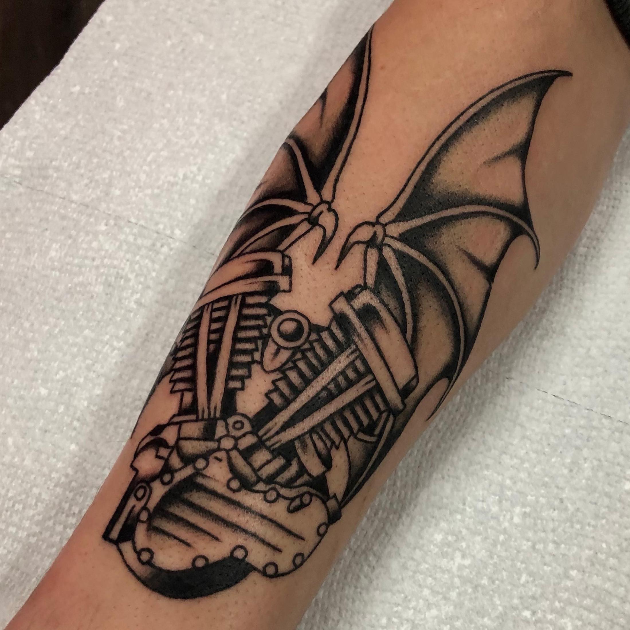 Mechanical bat geometric tattoo on the forearm by brenden
