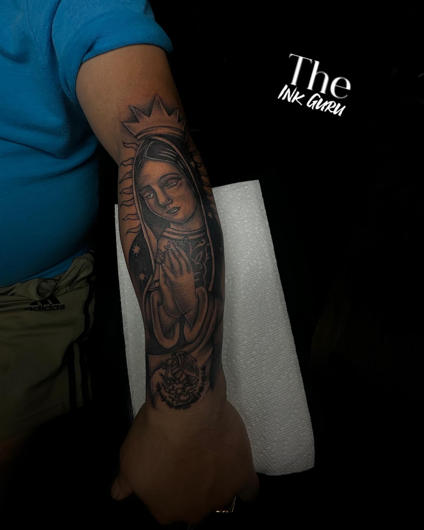 Virgin Mary black and grey tattoo on the forearm by The Ink Guru.
