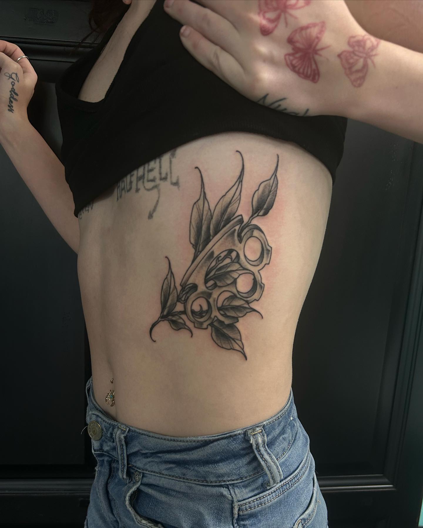 Skull and roses black and grey tattoo on the ribs by Ares Rhodes