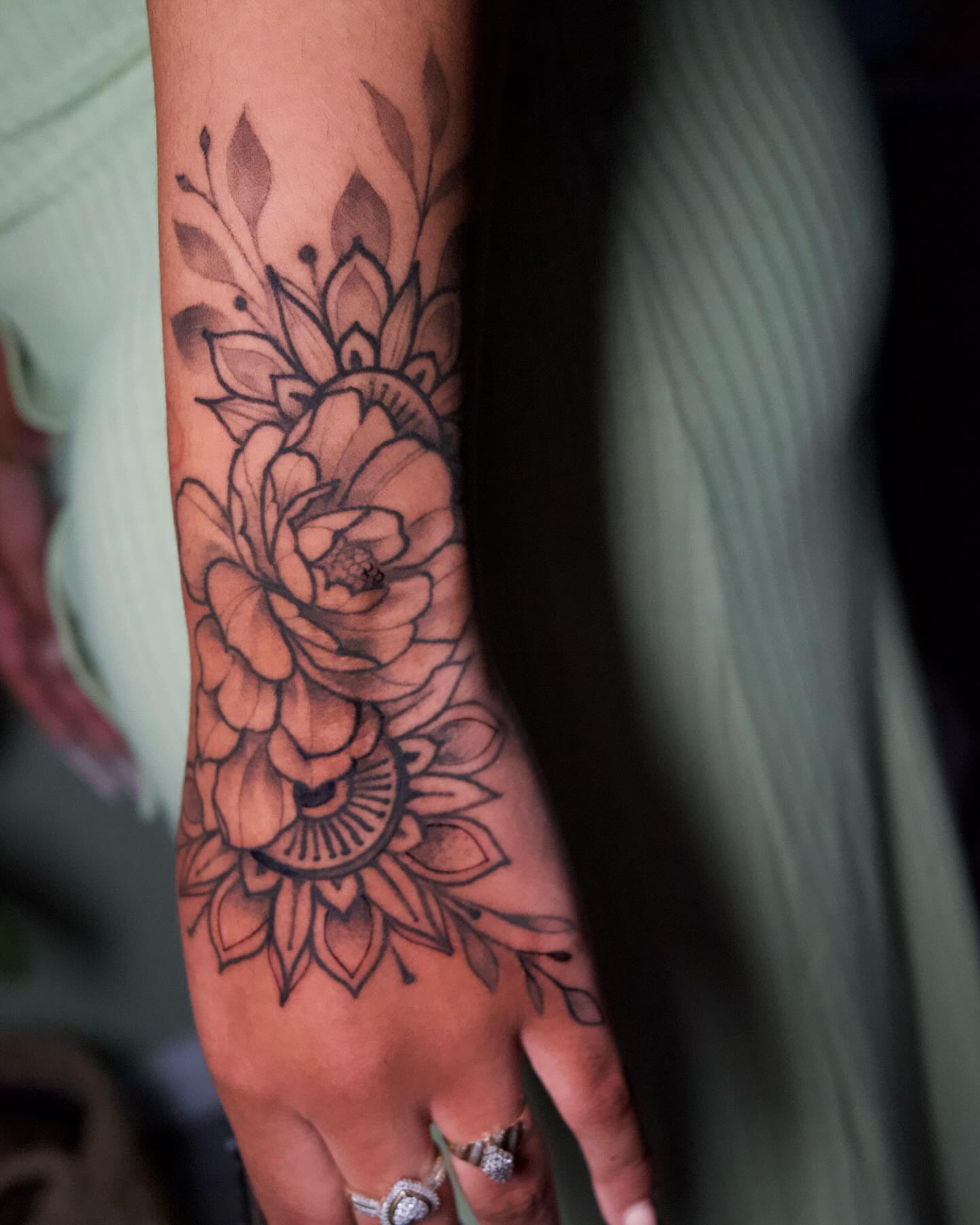 Floral design black and grey tattoo on the forearm by Neri Gersaint
