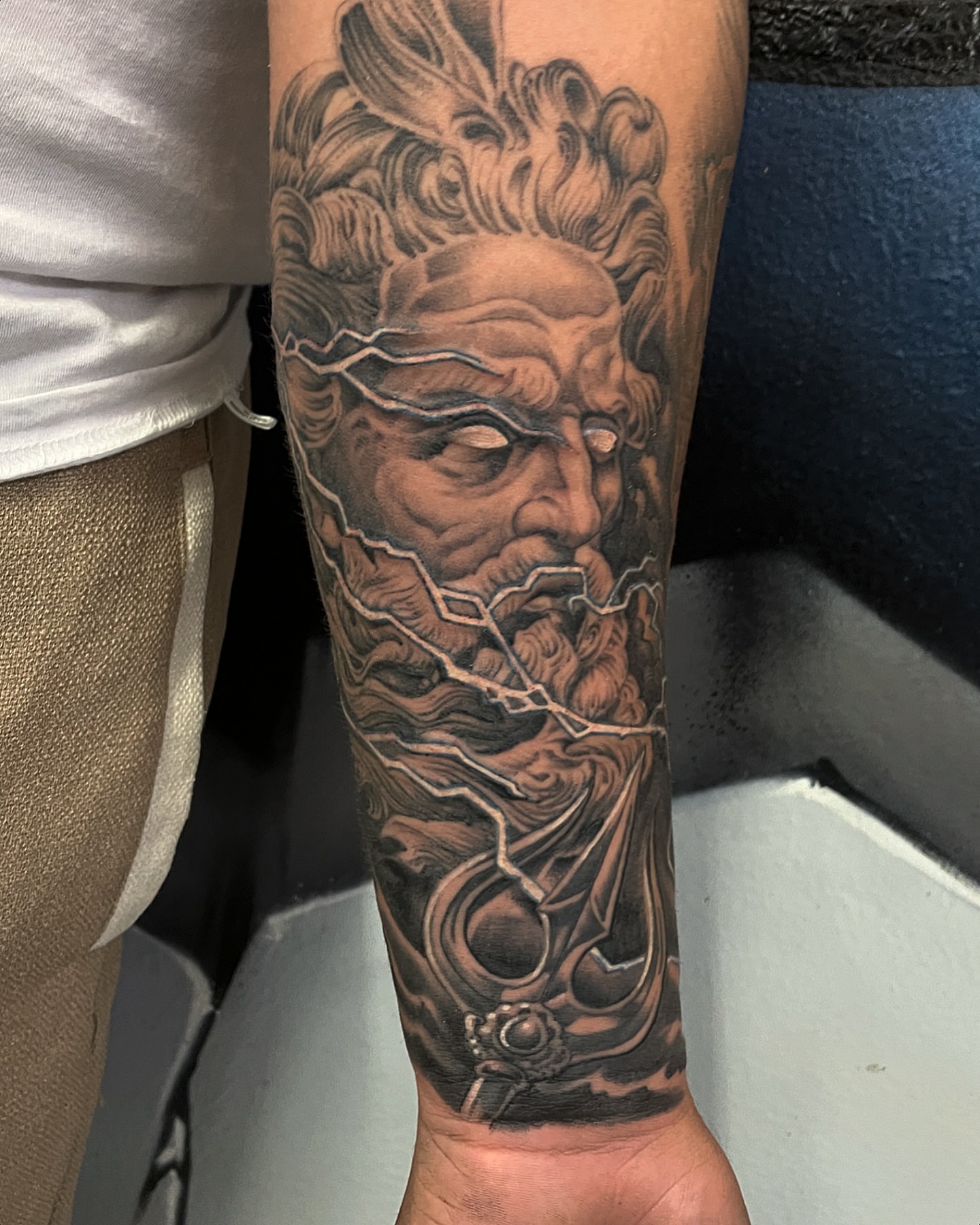 God-like figure realism tattoo on the forearm by Manny