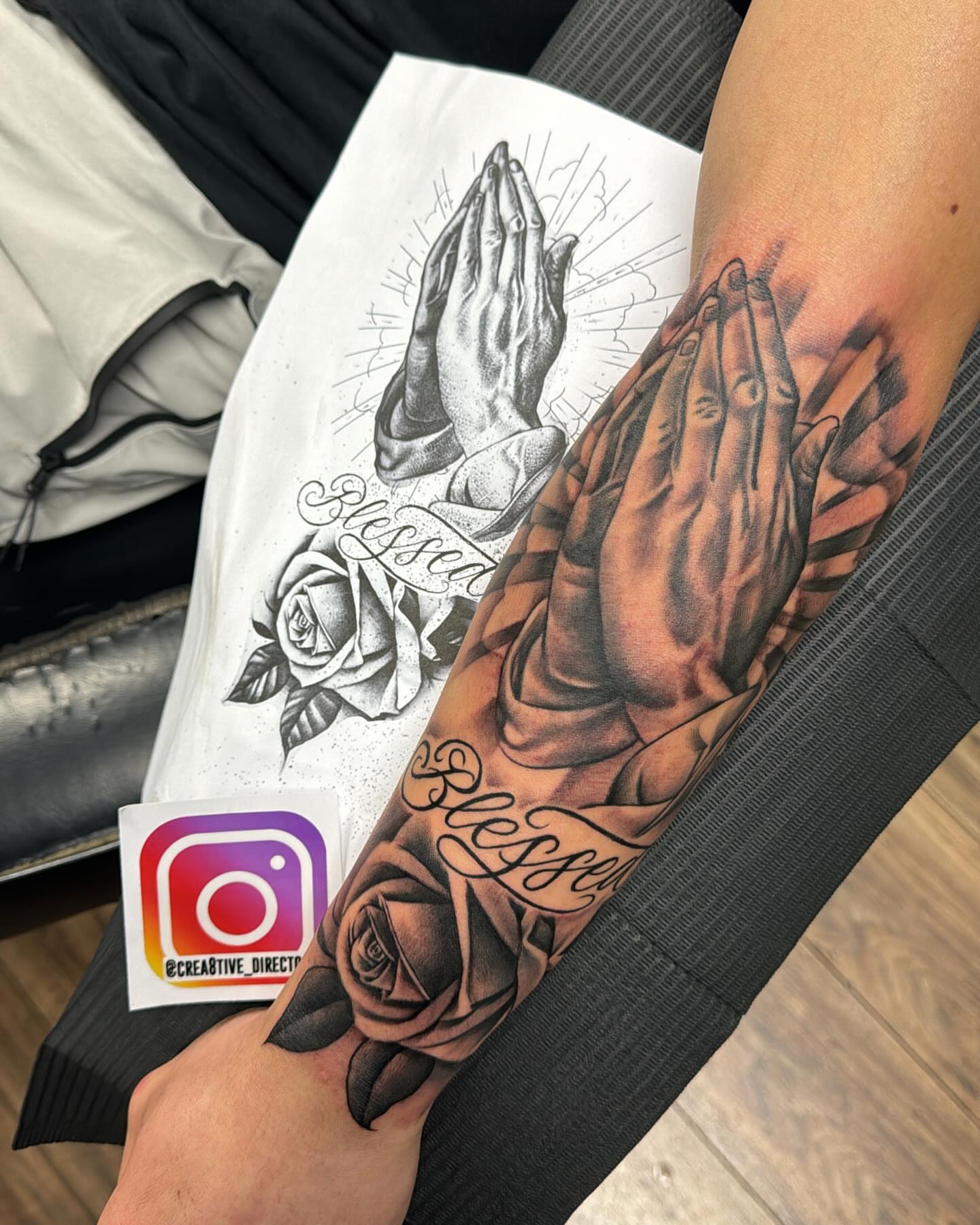 Praying hands black and grey tattoo on the forearm by Cedric Fleming