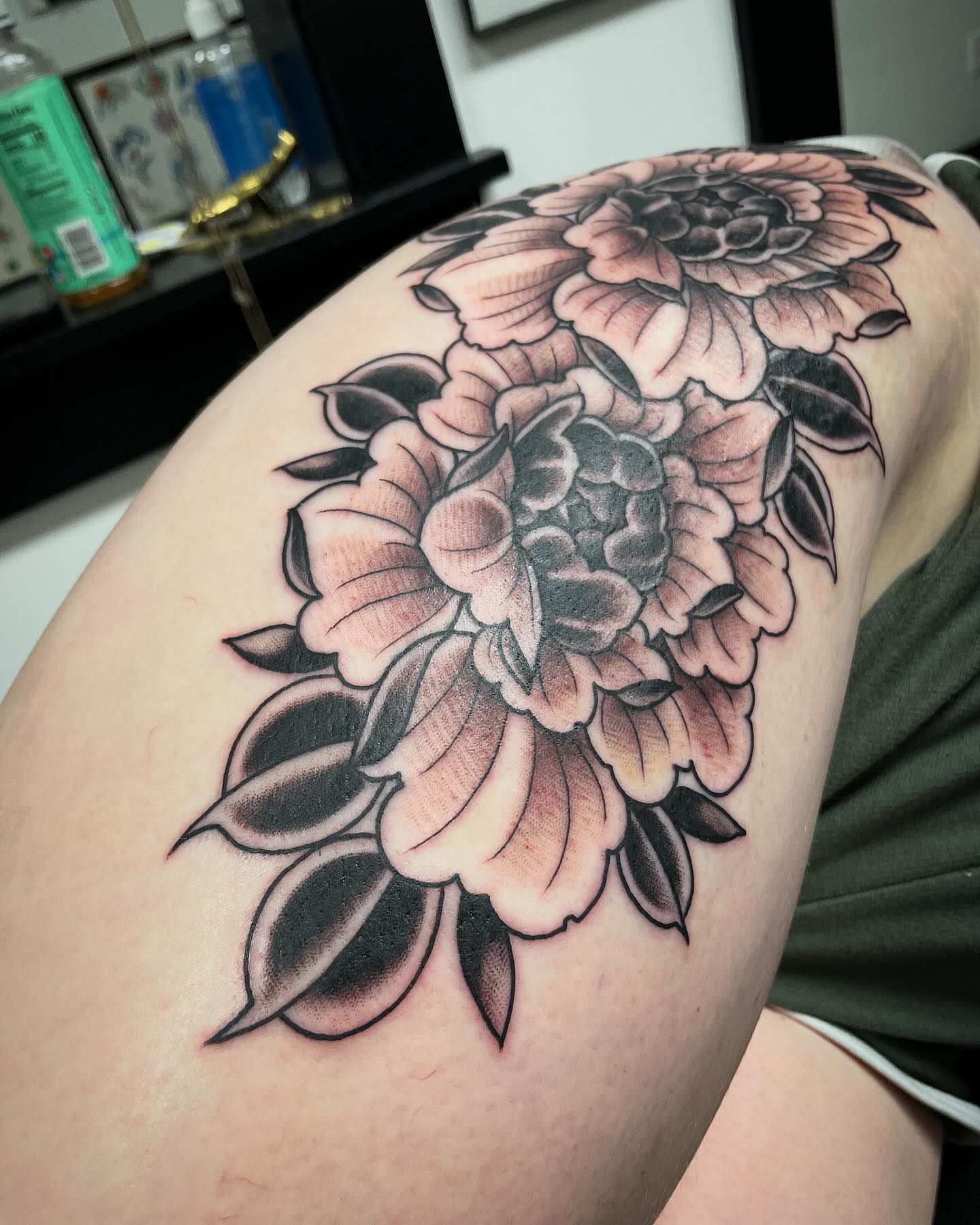 Peony flowers black and grey tattoo on the thigh by JoDee Yates