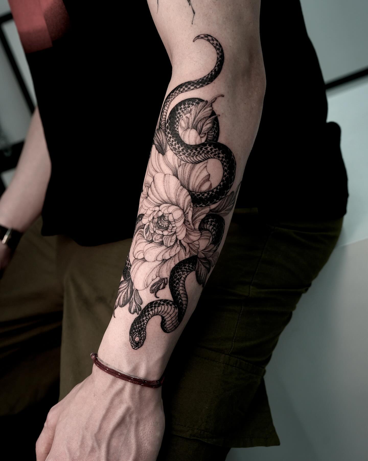 Snake and peony black and grey tattoo on the forearm by Yongjun