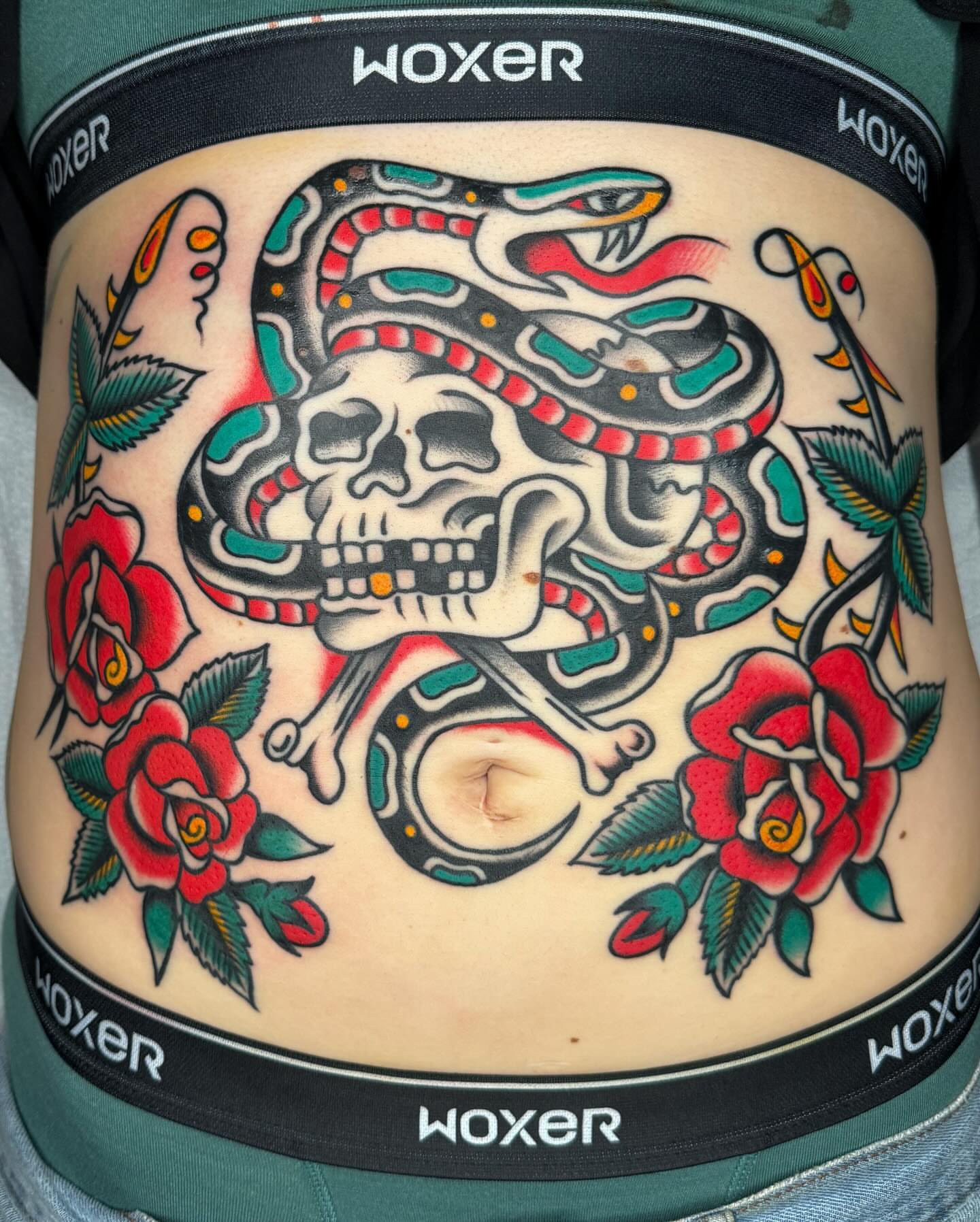 Snake and skull American traditional tattoo on the torso by James Shepherd, Austin, Texas