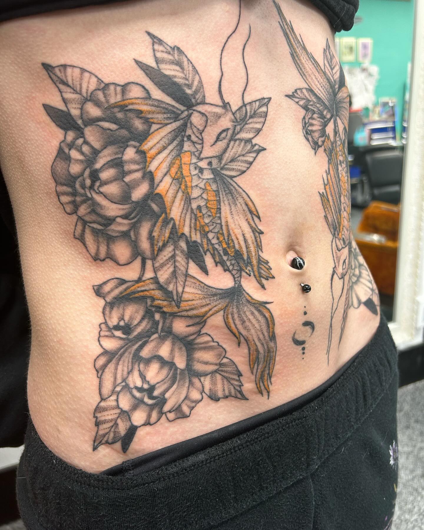 Peony and dragonfly American traditional tattoo on the ribs by Jayda Shell