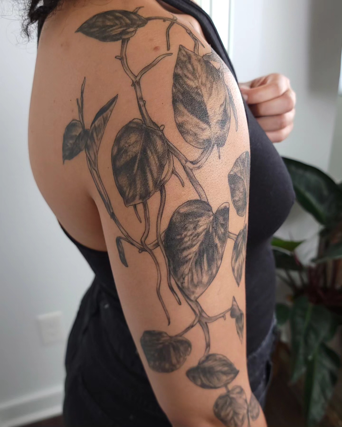 Plant vines dotwork tattoo on the upper arm by Ghost