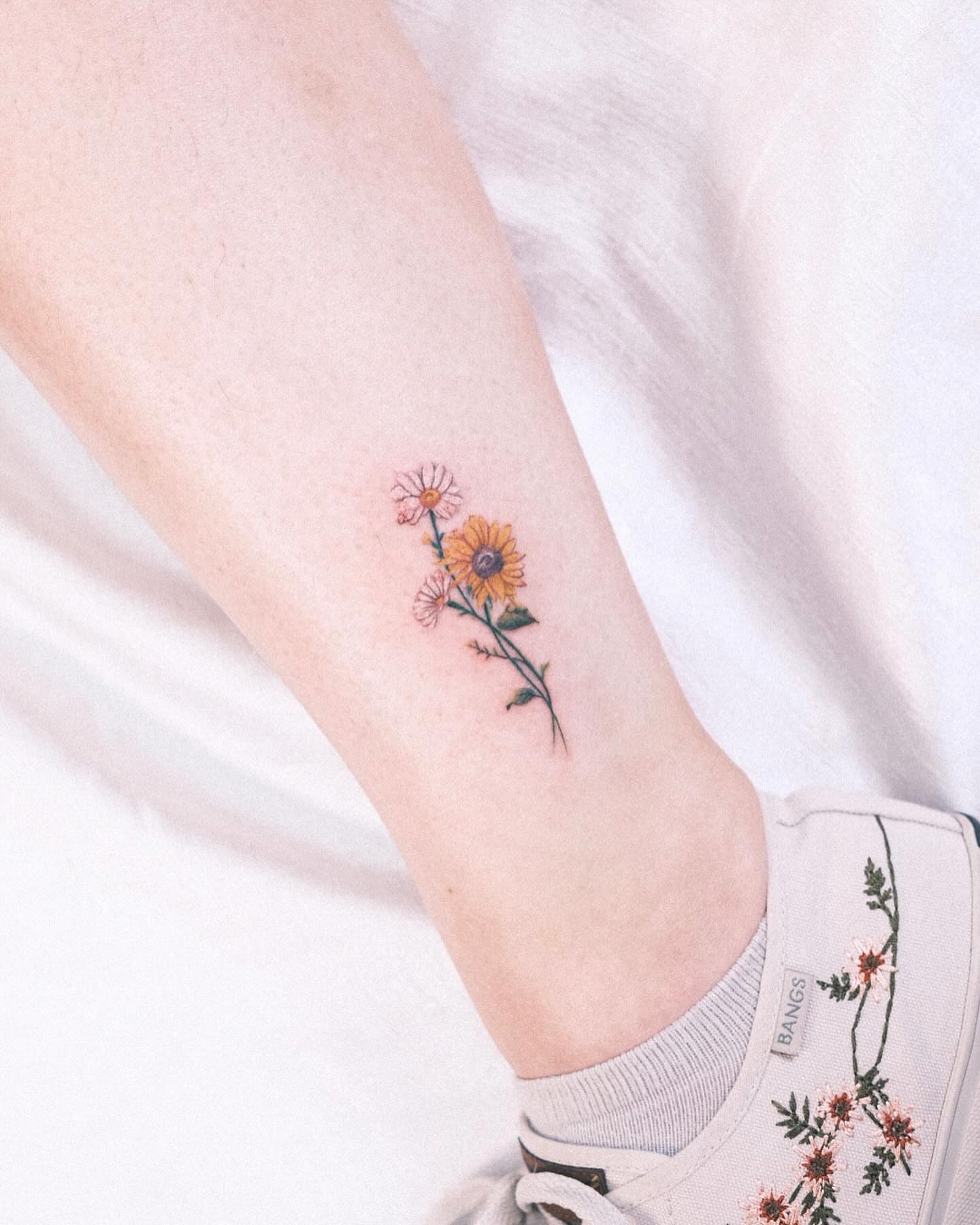 Flowers dotwork tattoo on the forearm by Henry
