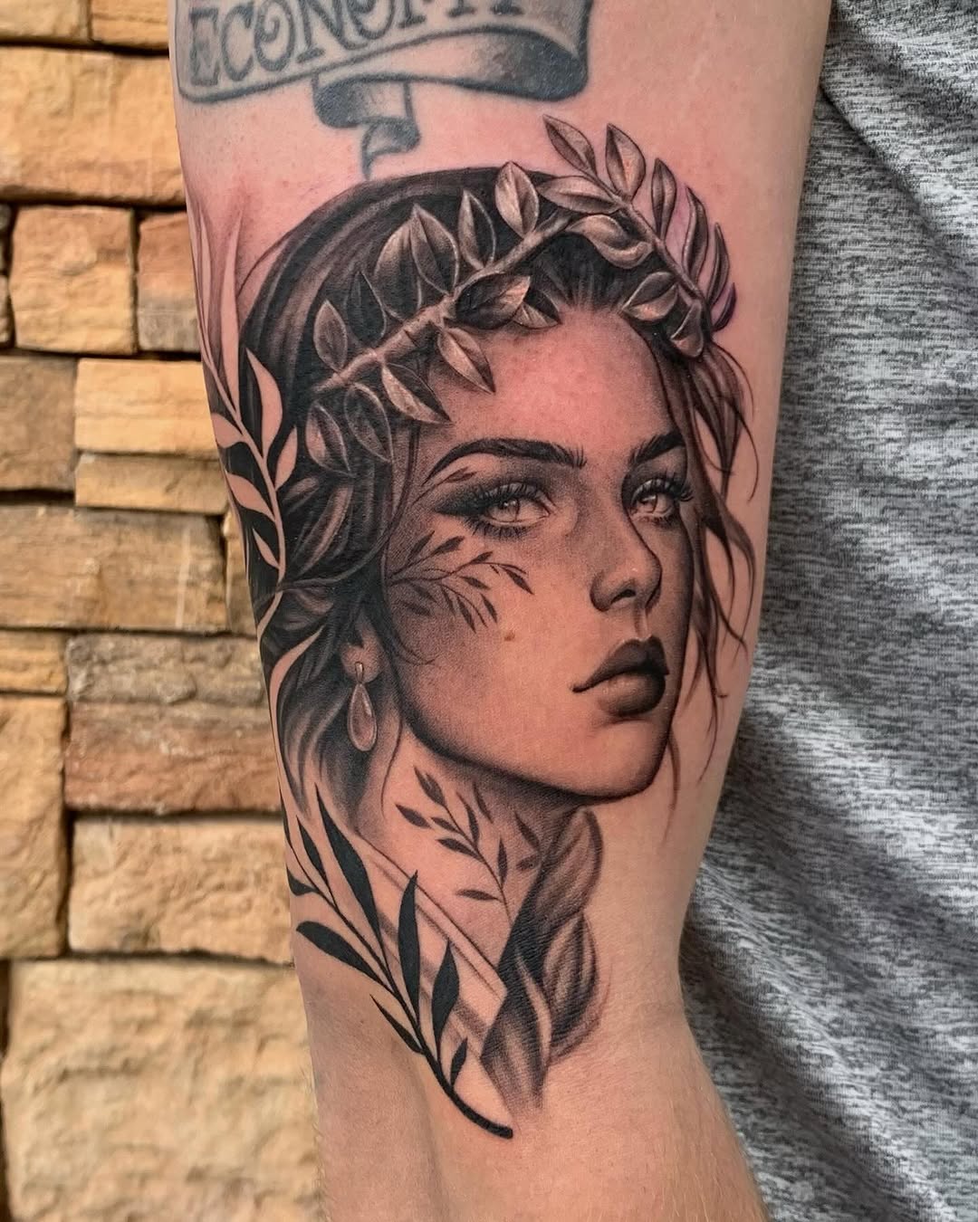 Woman with laurel wreath realism tattoo on the forearm by Winters Ashurst - St. George tattoo artist