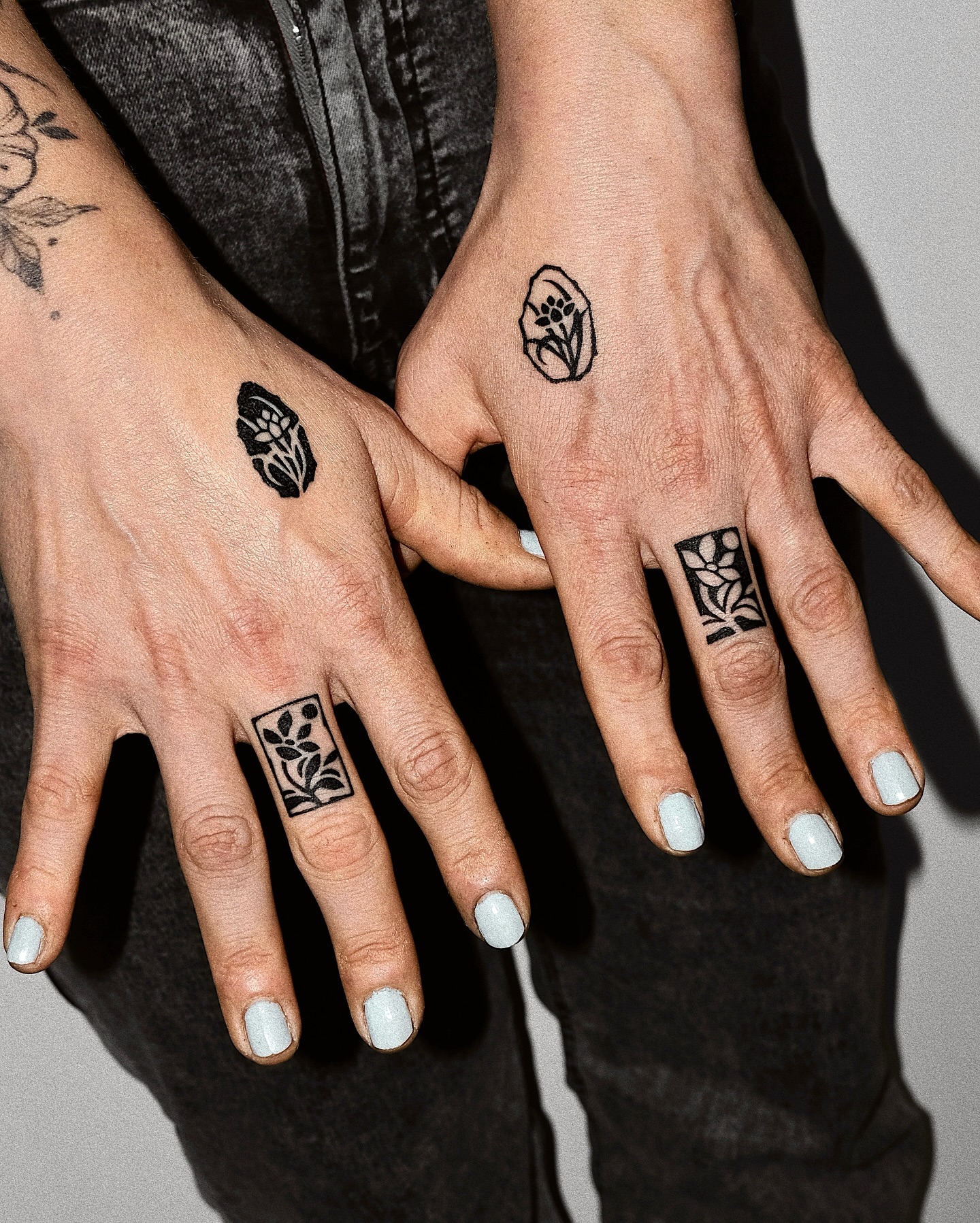 Floral motif black and grey tattoo on the hand by Mooro