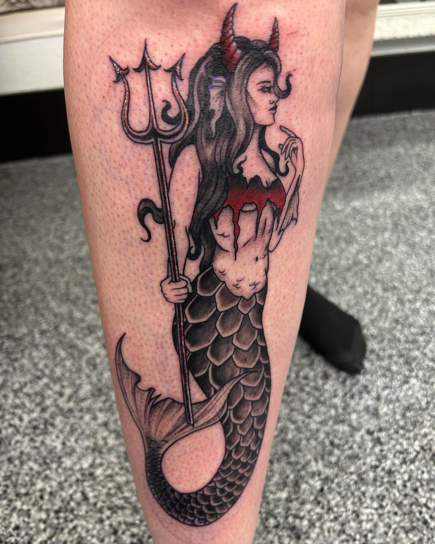 Mermaid with trident realism tattoo on the leg by Jayda Shell