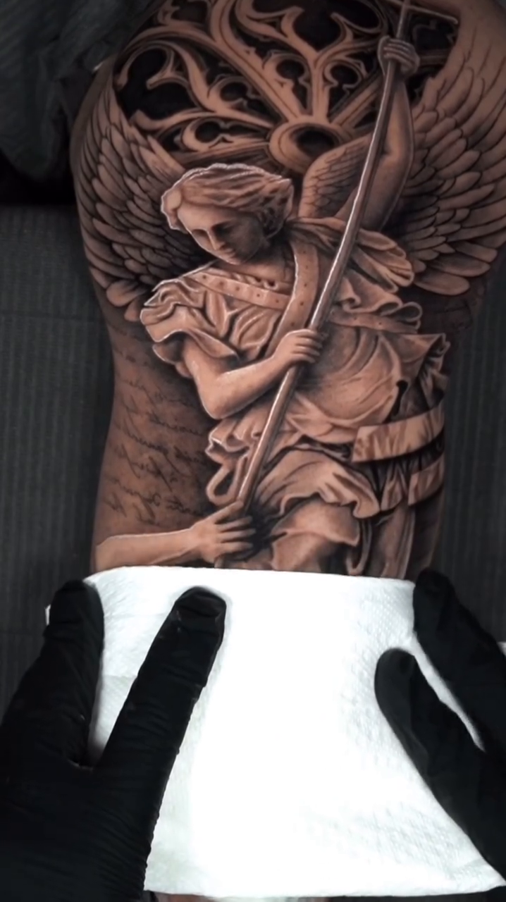 Archangel Michael battling a demon realism tattoo by Jesus Alonso