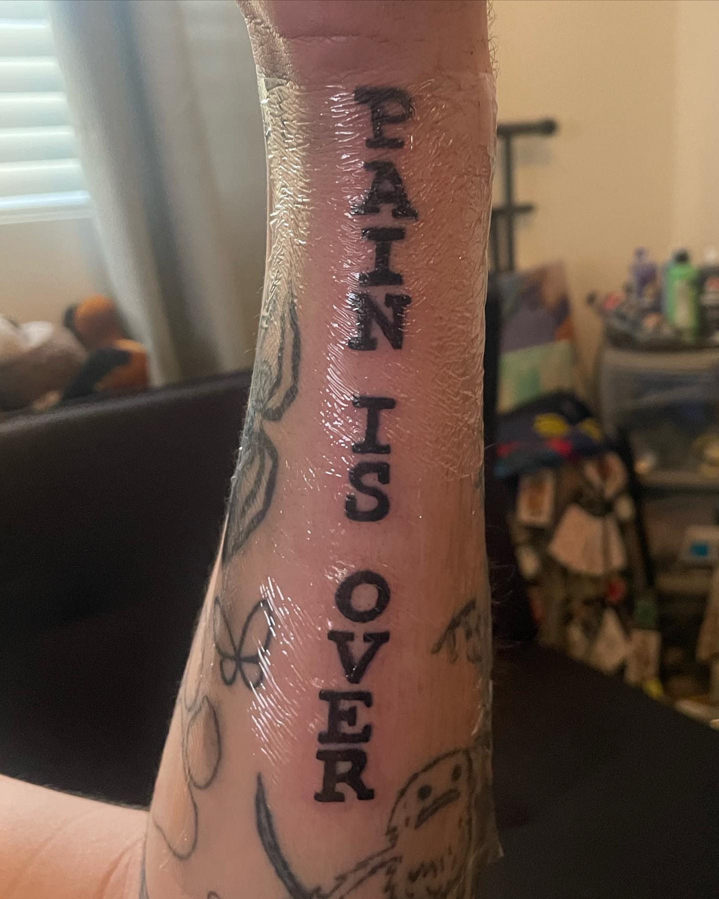 Pain is over lettering script tattoo on the forearm by ART