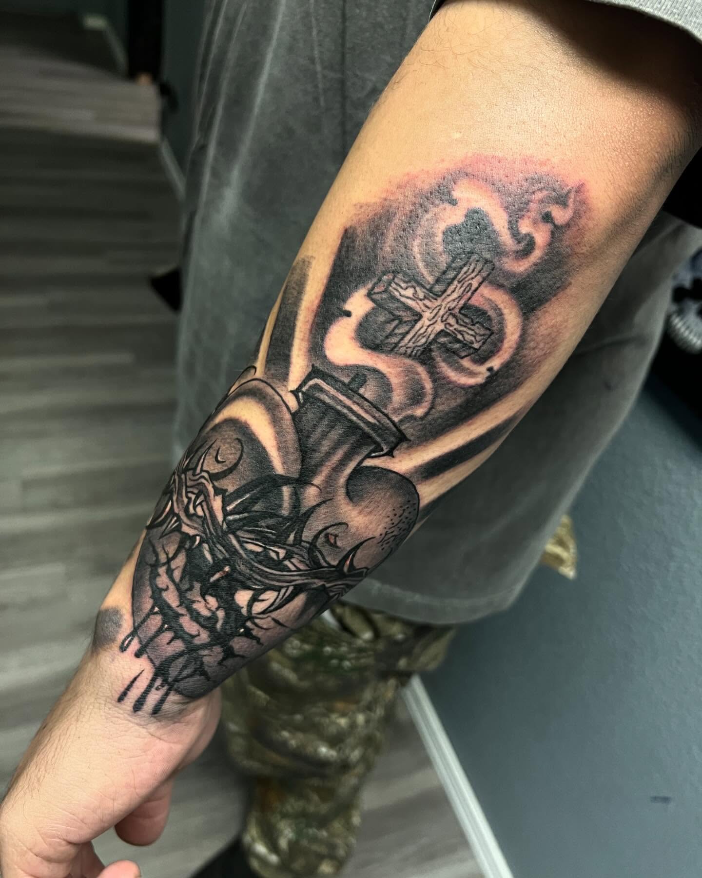 Cross and skull realism tattoo on the forearm by Smuk One