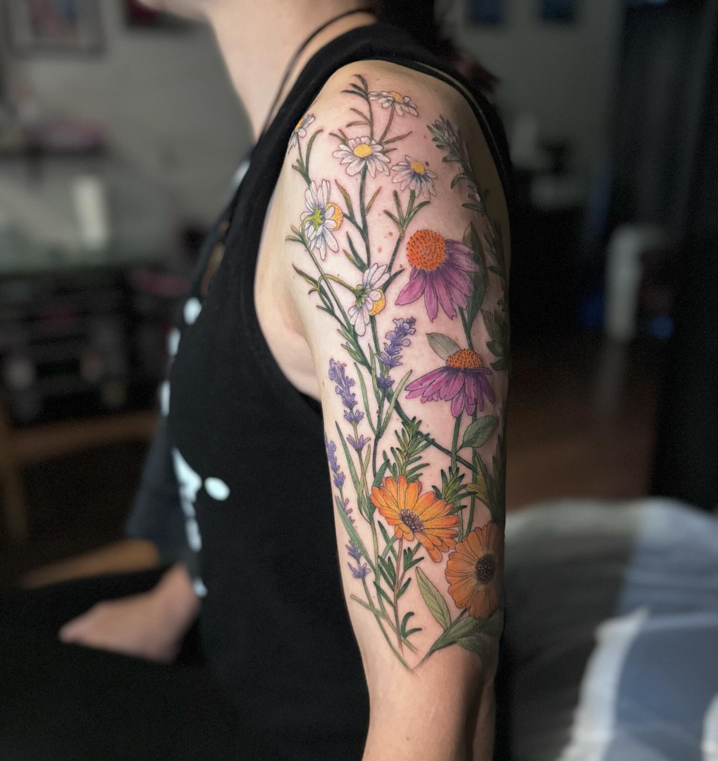 Wildflowers realism tattoo on the upper arm by đź’›Kristinađź’› tattoos with intention, Minneapolis, Minnesota